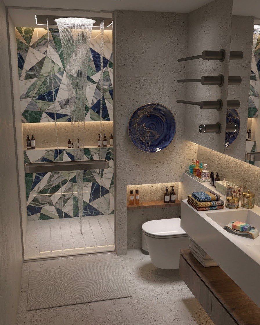 Geometric patterned tiles in blue and green marble decorate the wall inside a modern walk-in shower.