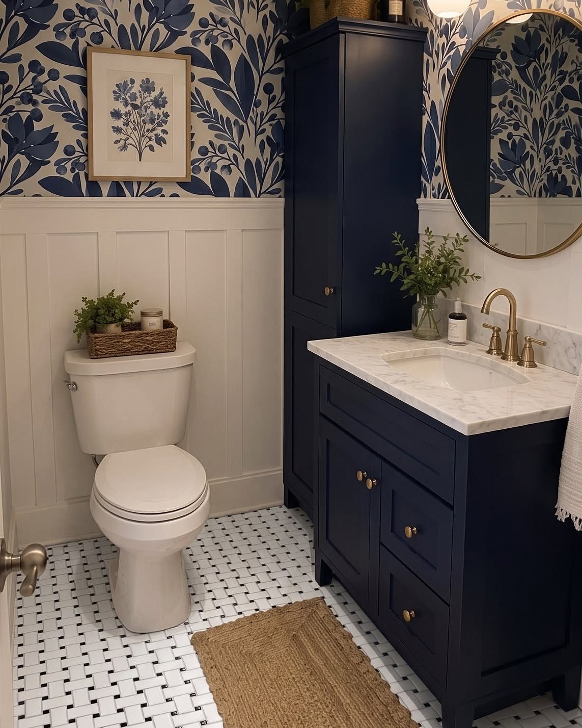 White and black basketweave pattern tiles on a bathroom floor with navy blue vanity and toilet.