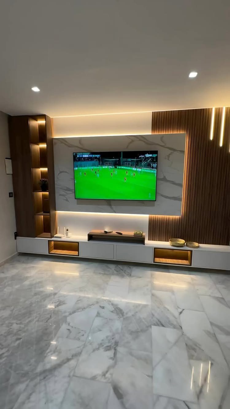 White marble flooring in a modern living room with wood accents and warm lighting.