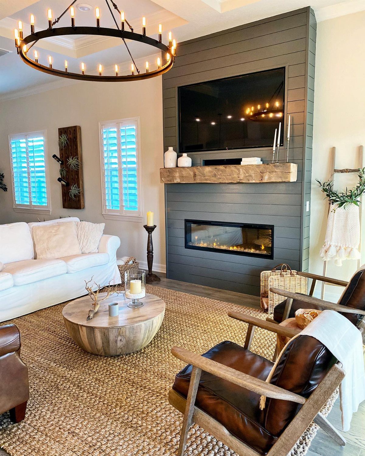 Interior Wall Design: 5 Rooms That Climb Off the Surface 4 Dark gray shiplap accent wall with a fireplace, wooden mantel, and mounted television in a living room.