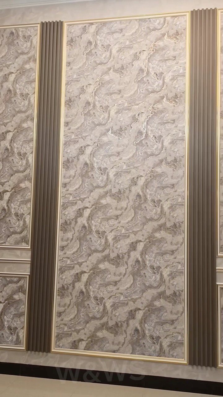Interior Wall Design: 5 Rooms That Climb Off the Surface 1 Marble patterned wall panels framed by gold borders and brown fluted vertical moldings.