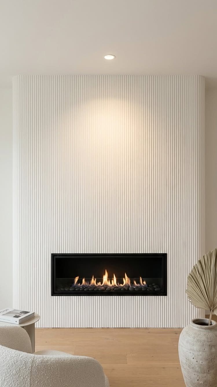 Interior Wall Design: 5 Rooms That Climb Off the Surface 5 White fluted accent wall with a modern black linear fireplace and warm flames.