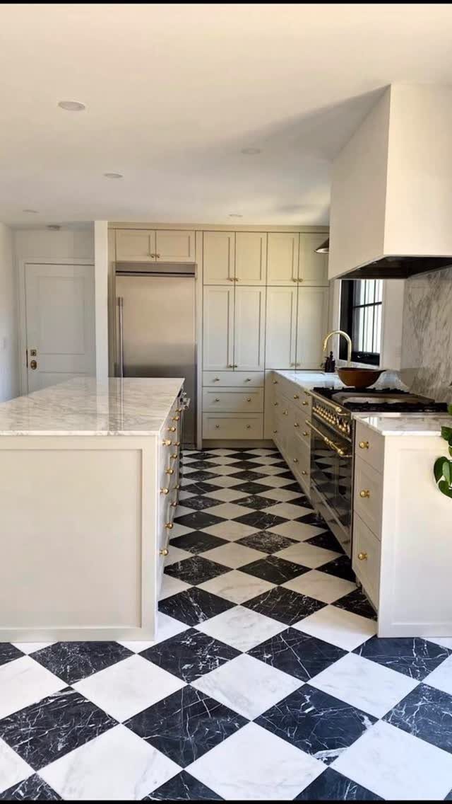 Kitchen Flooring for White Cabinets: 11 Ideas That Actually Work 3 Black and white marble checkerboard flooring in a modern white kitchen with an island.