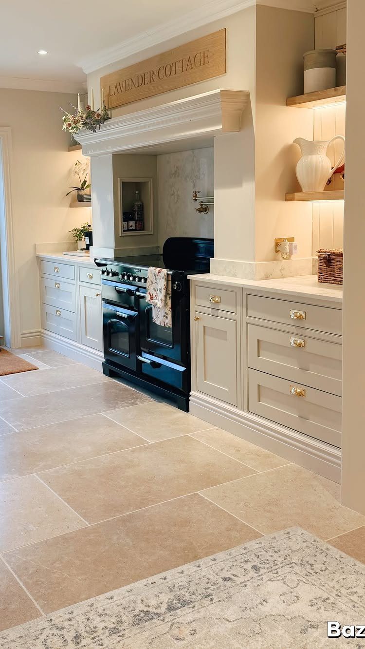 Kitchen Flooring for White Cabinets: 11 Ideas That Actually Work 4 Beige limestone tiles laid across a bright kitchen floor with white cabinets.