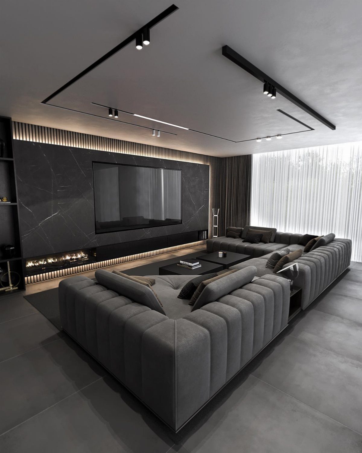 Charcoal grey marble accent wall with an integrated television and fireplace in a modern living room.