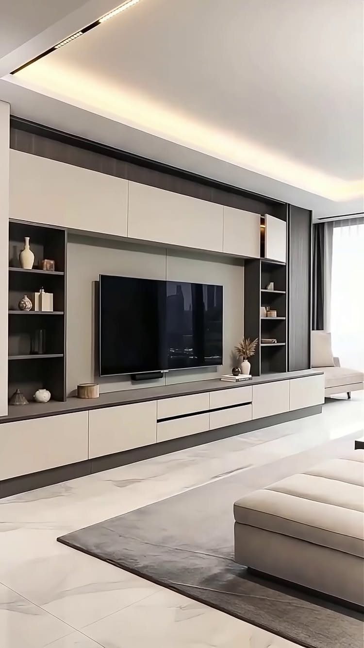 Modern built-in media center with light cabinetry, open shelving, and a large television in a living room.