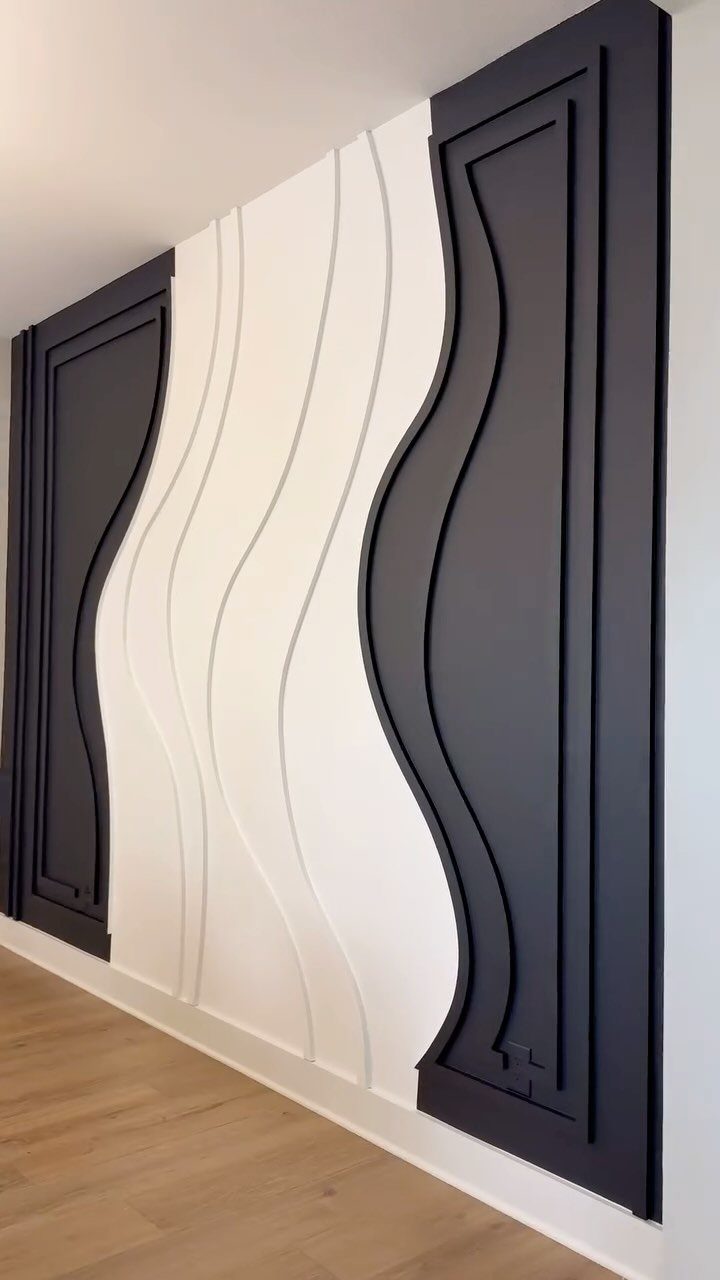 Modern wavy wainscoting panels in navy blue and white on a feature wall.