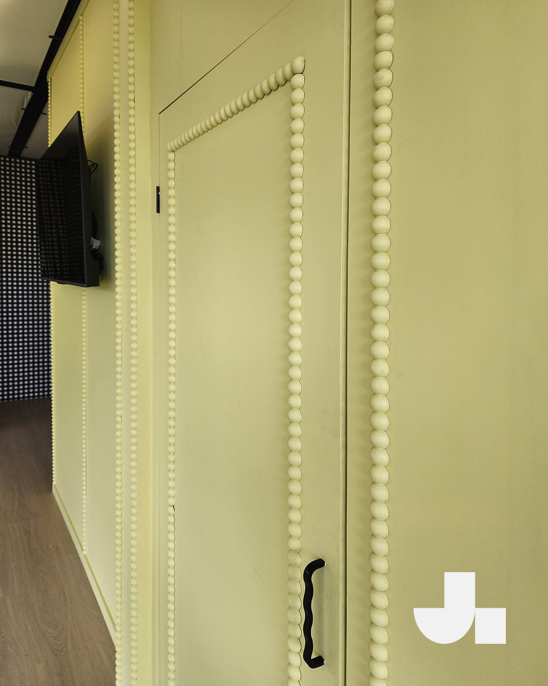 Wall Moulding Design: 11 Styles That Work in Every Room 6 Pale yellow wall featuring decorative bead-style moulding arranged in rectangular patterns.