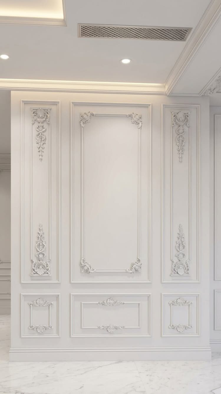 Wall Moulding Design: 11 Styles That Work in Every Room 8 Ornate white wall moulding with classical decorative carvings and rectangular paneling on a light wall.