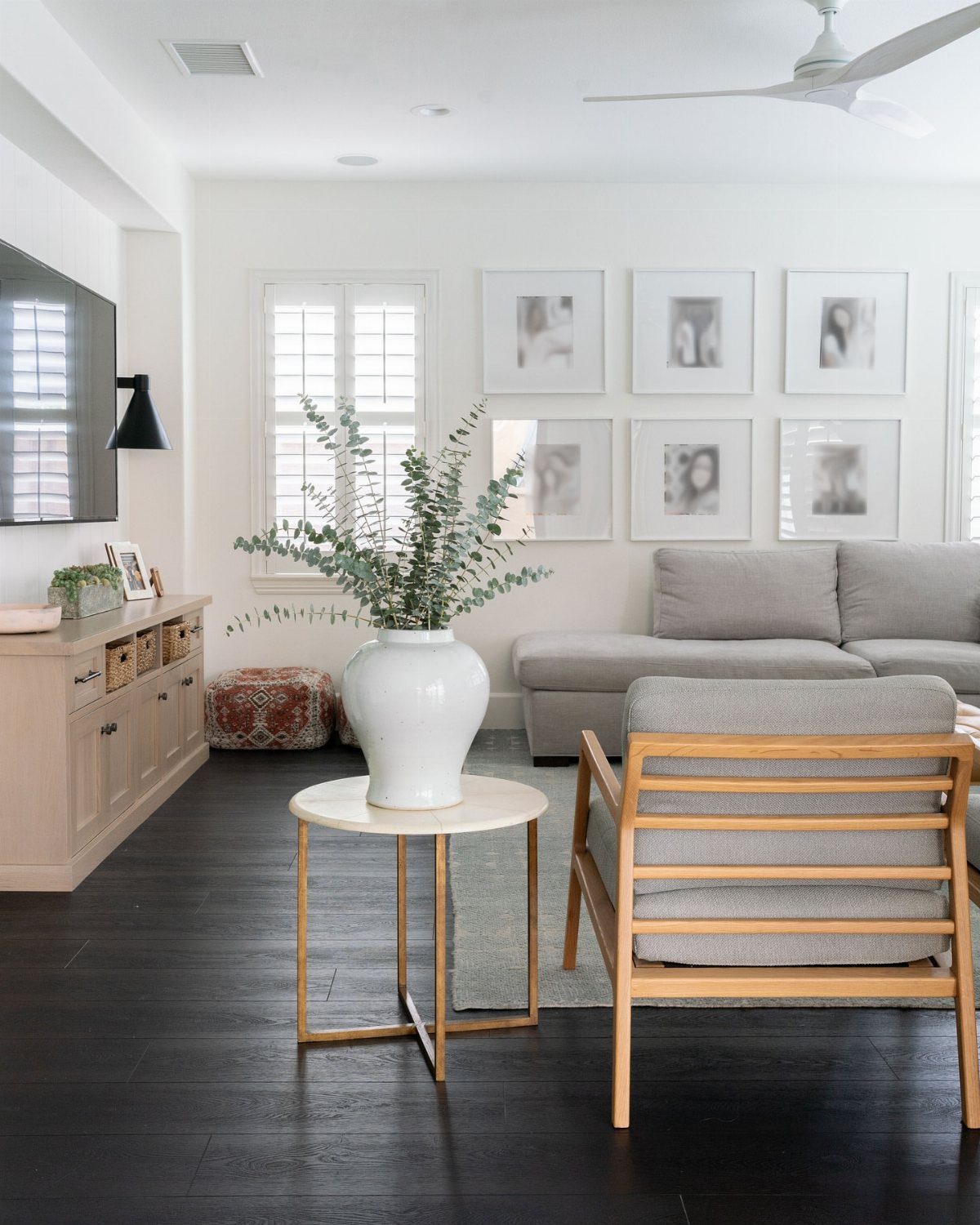 Dark black stained wood flooring in a bright, modern living room setting.