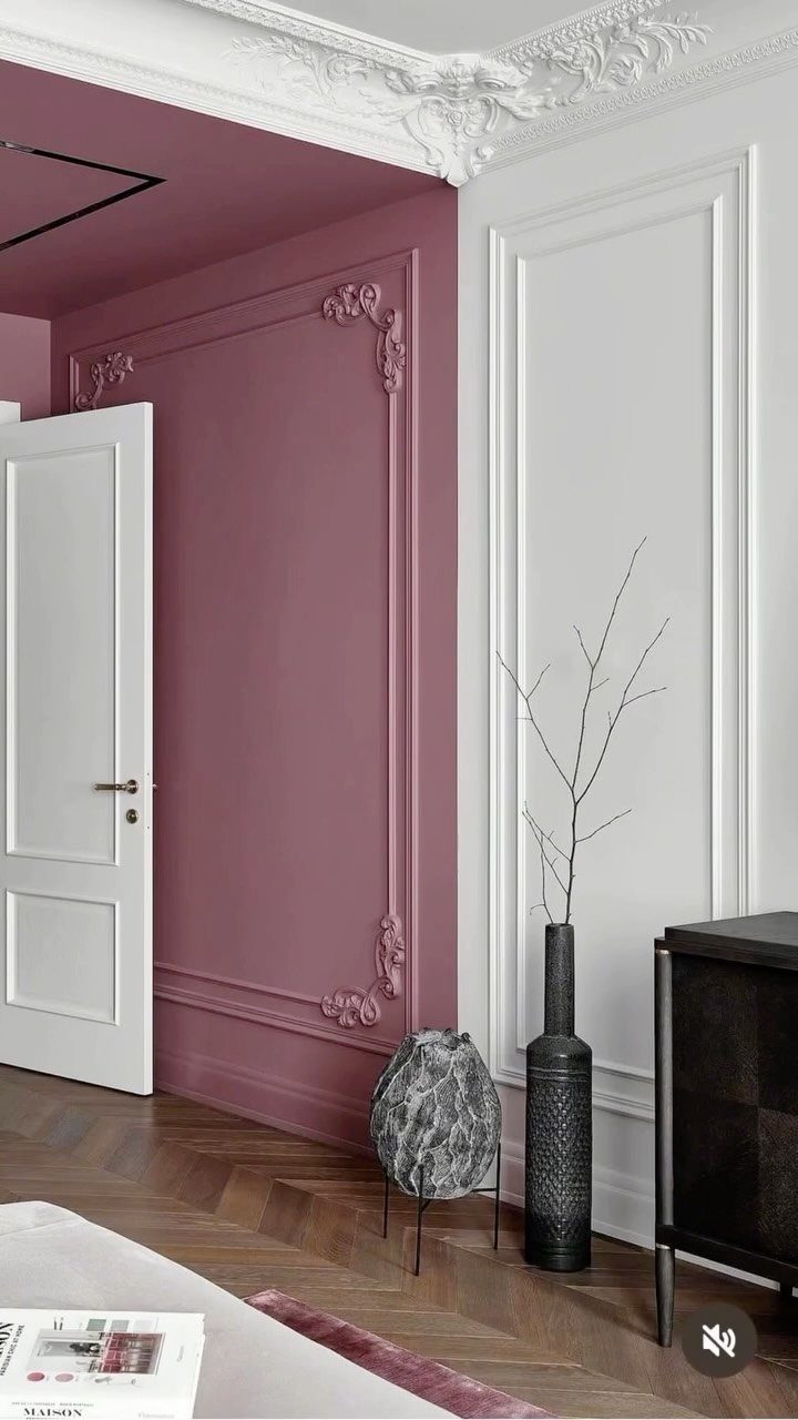 Dusty rose and white walls featuring decorative picture frame molding in a modern room.
