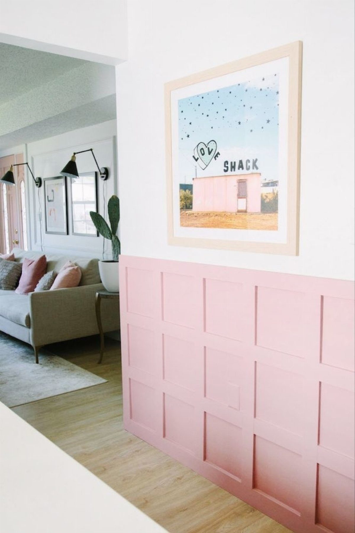Types of Wall Paneling: 10 Styles for Any Room 4 Pink wainscoting wall paneling with a rectangular grid pattern in a bright room.