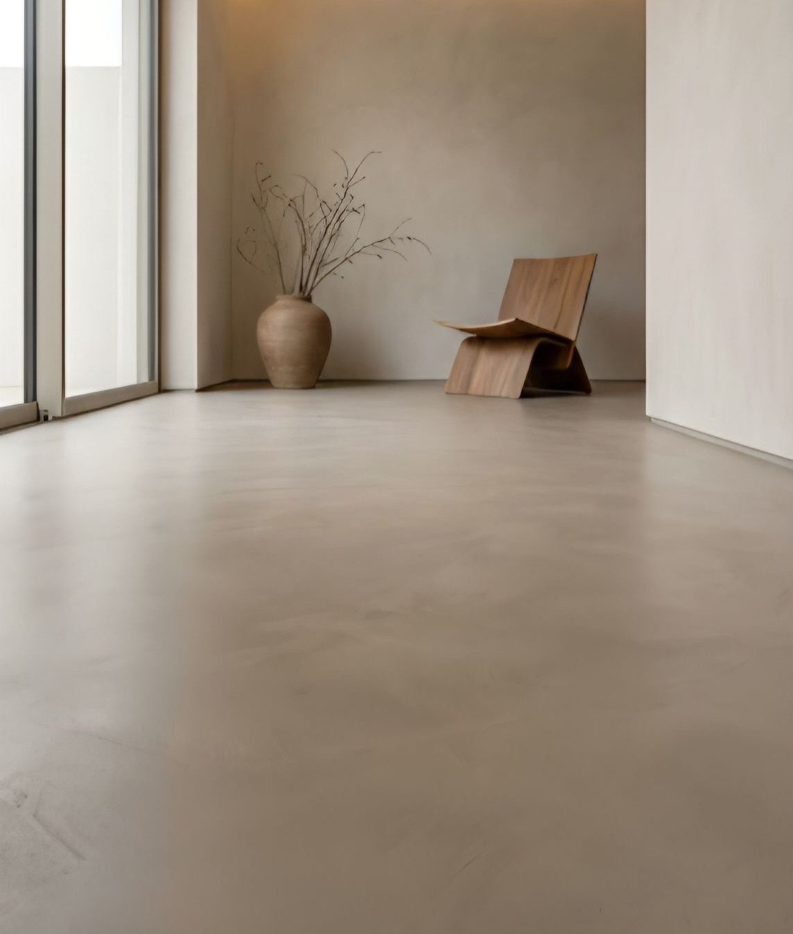 Smooth beige flooring in a minimalist room with a wooden chair and ceramic vase.