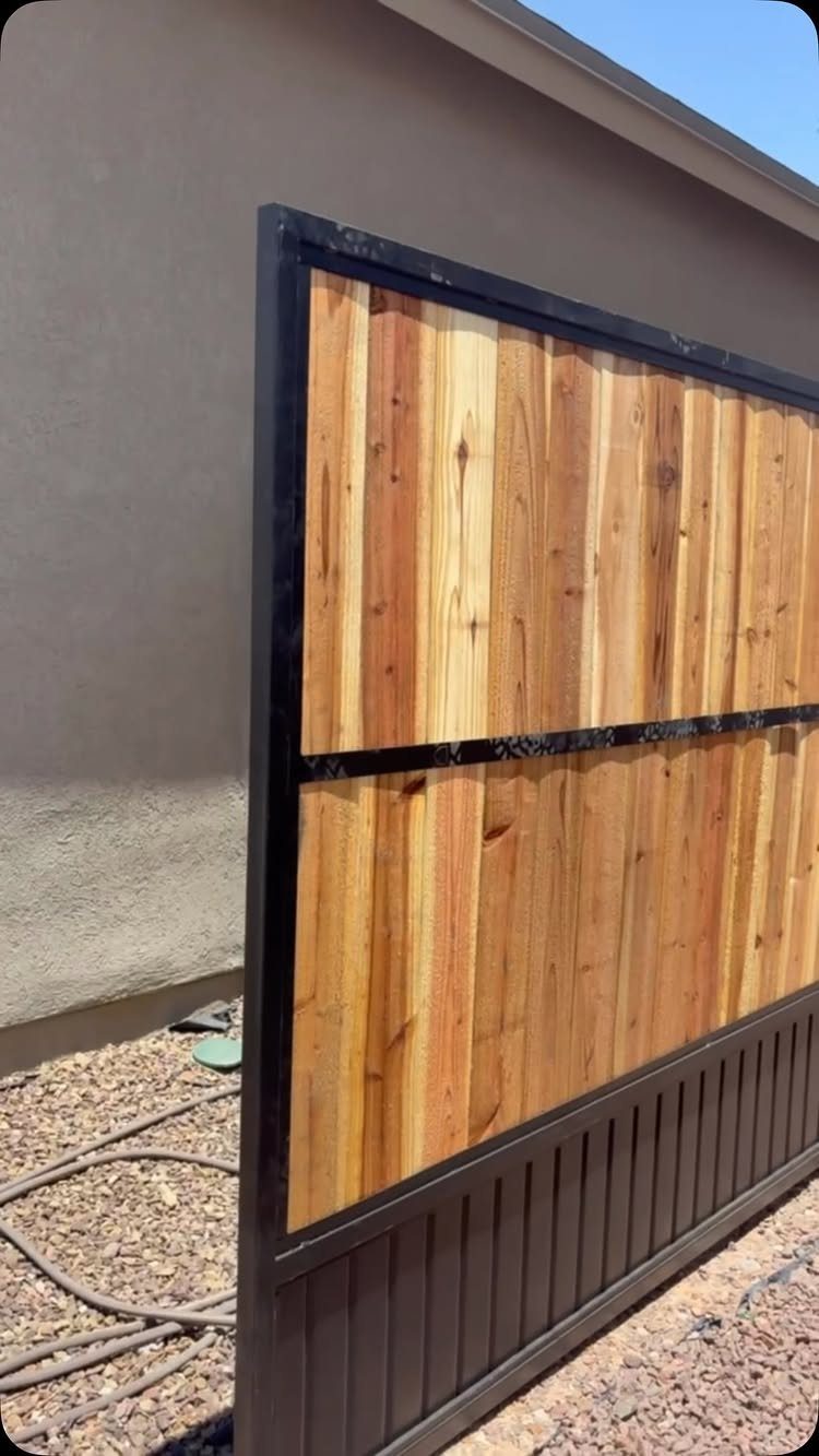 Cedar wood planks set within a black metal frame in a gravel yard.