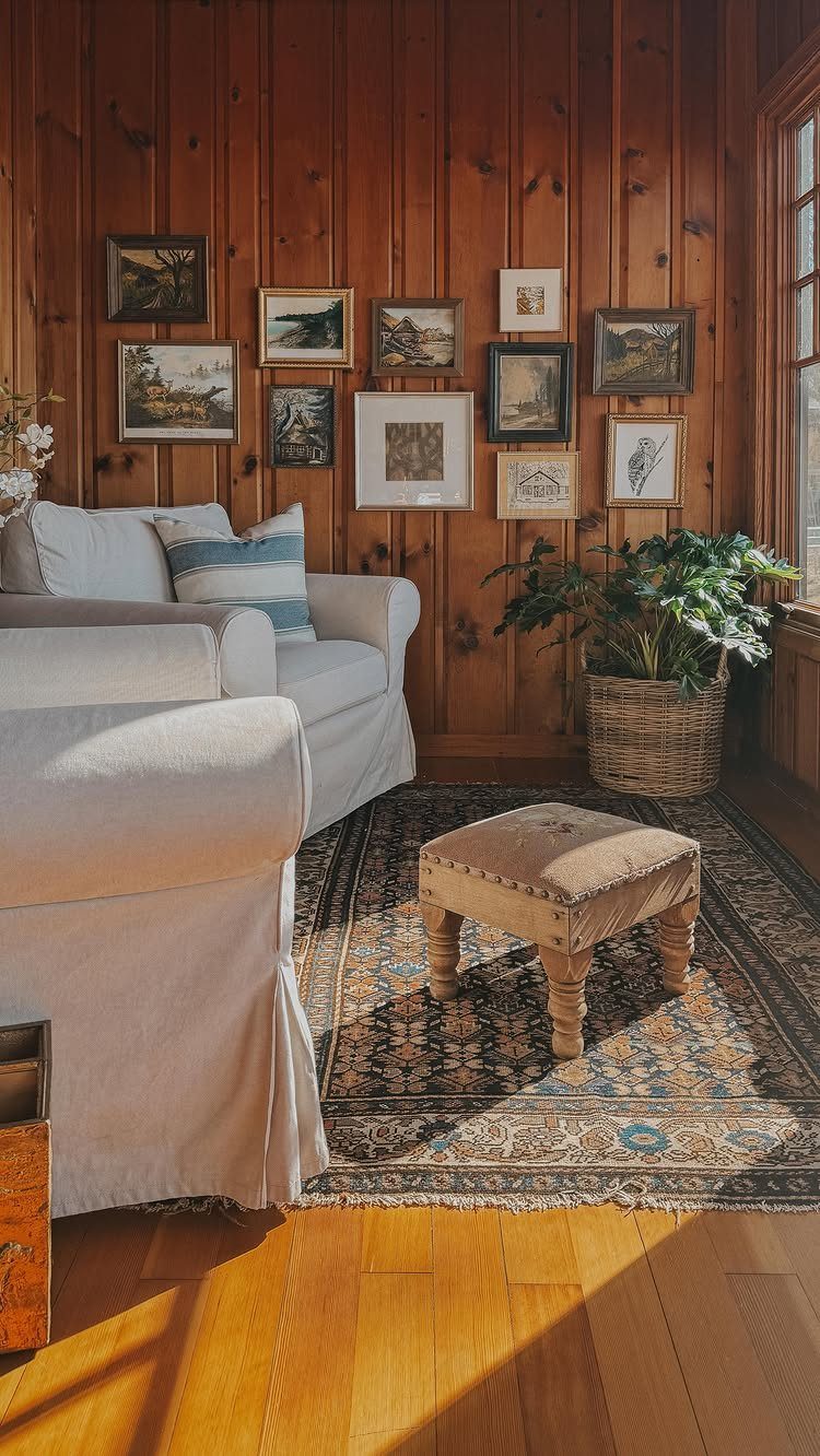 Wood Panelling on Walls: 8 Styles That Read as Architecture 7 Vertical wood panelling on a wall behind a white sofa and patterned rug.